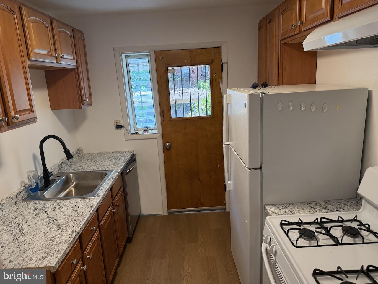 5032 Sargent Road Northeast Washington, DC 20017 - Photo 13 of 40 a kitchen with sink a refrigerator and stove