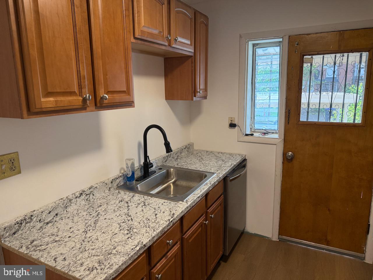 5032 Sargent Road Northeast Washington, DC 20017 - Photo 15 of 40 a kitchen with stainless steel appliances granite countertop a sink stove and refrigerator