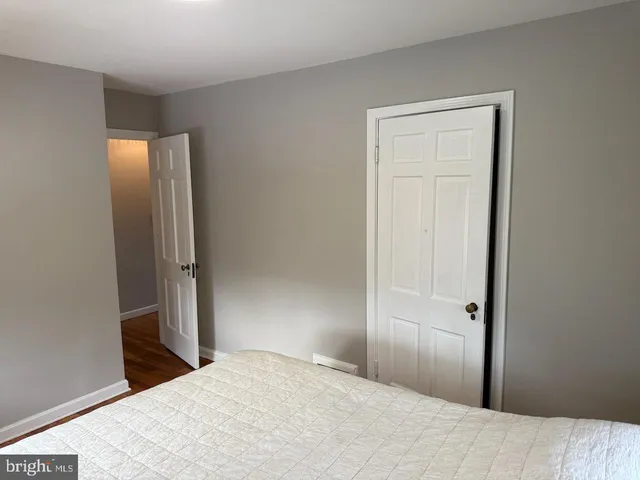 a bedroom with a bed and a mirror