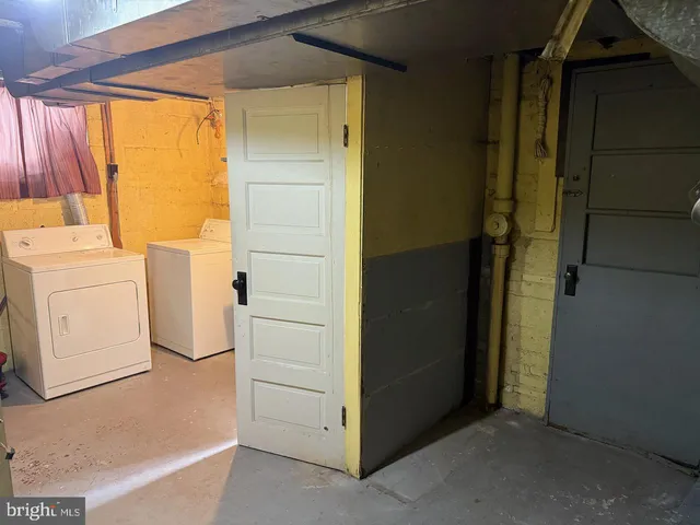 a utility room with closet dryer and washer