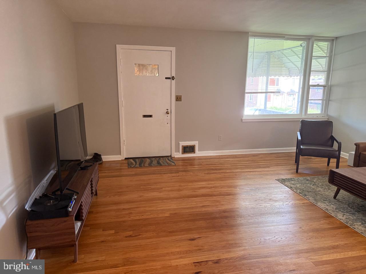 5032 Sargent Road Northeast Washington, DC 20017 - Photo 5 of 40 a room with wooden floor and windows
