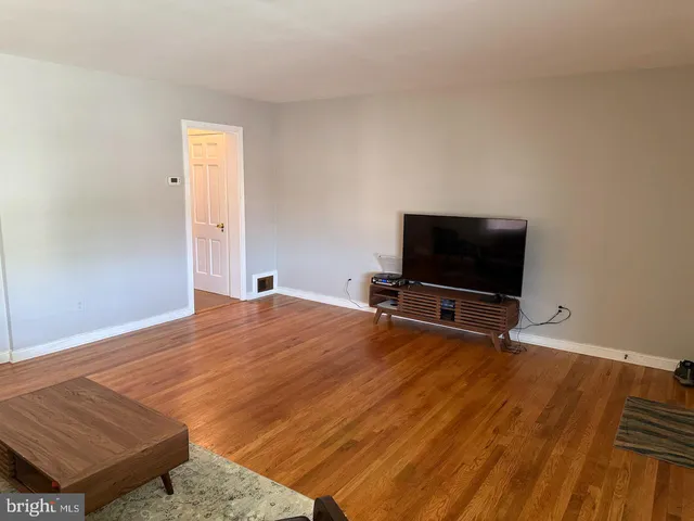 a living room with a flat screen tv and a couch