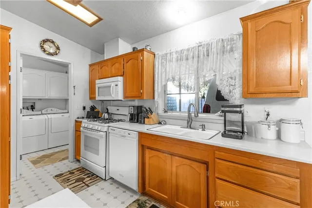 a kitchen with a sink cabinets and window