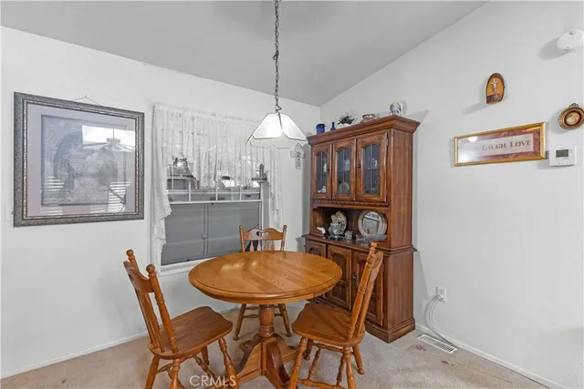 a dining room with furniture and window