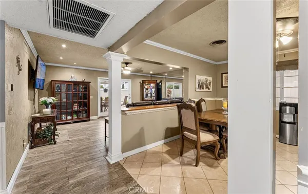 a view of a living room and entry way to kitchen