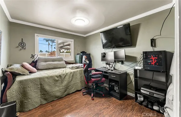 a living room with furniture a flat screen tv and a floor to ceiling window