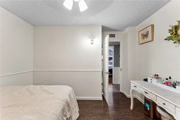 a room with a bed and wooden floor