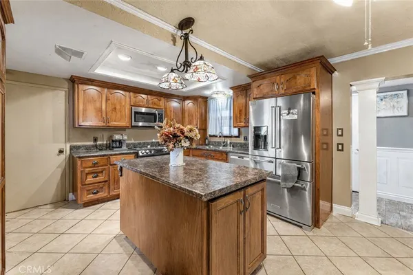 a kitchen with stainless steel appliances granite countertop a refrigerator and a stove top oven