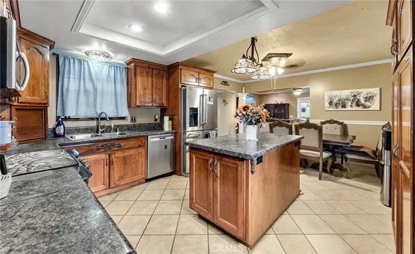 a kitchen with granite countertop a sink stove and cabinets
