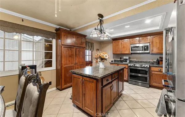 a kitchen with stainless steel appliances granite countertop a stove and a refrigerator