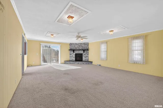 an empty room with furniture and a fireplace