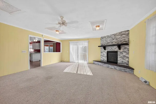 a big room with windows and fireplace