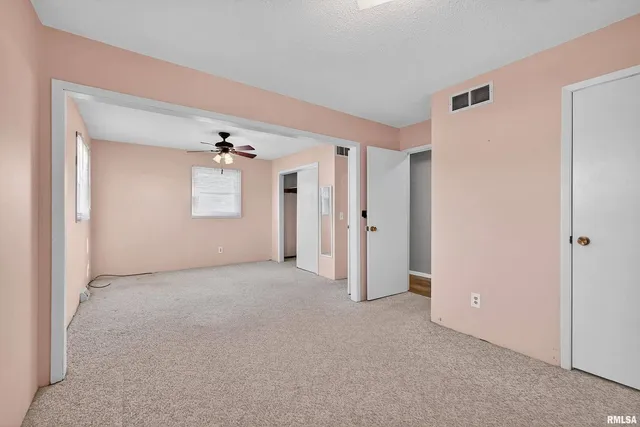 a view of a big room with chandelier and entryway