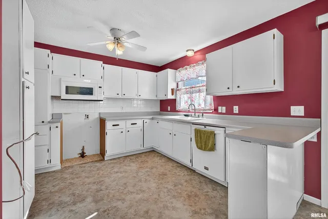 a kitchen with a sink cabinets and window