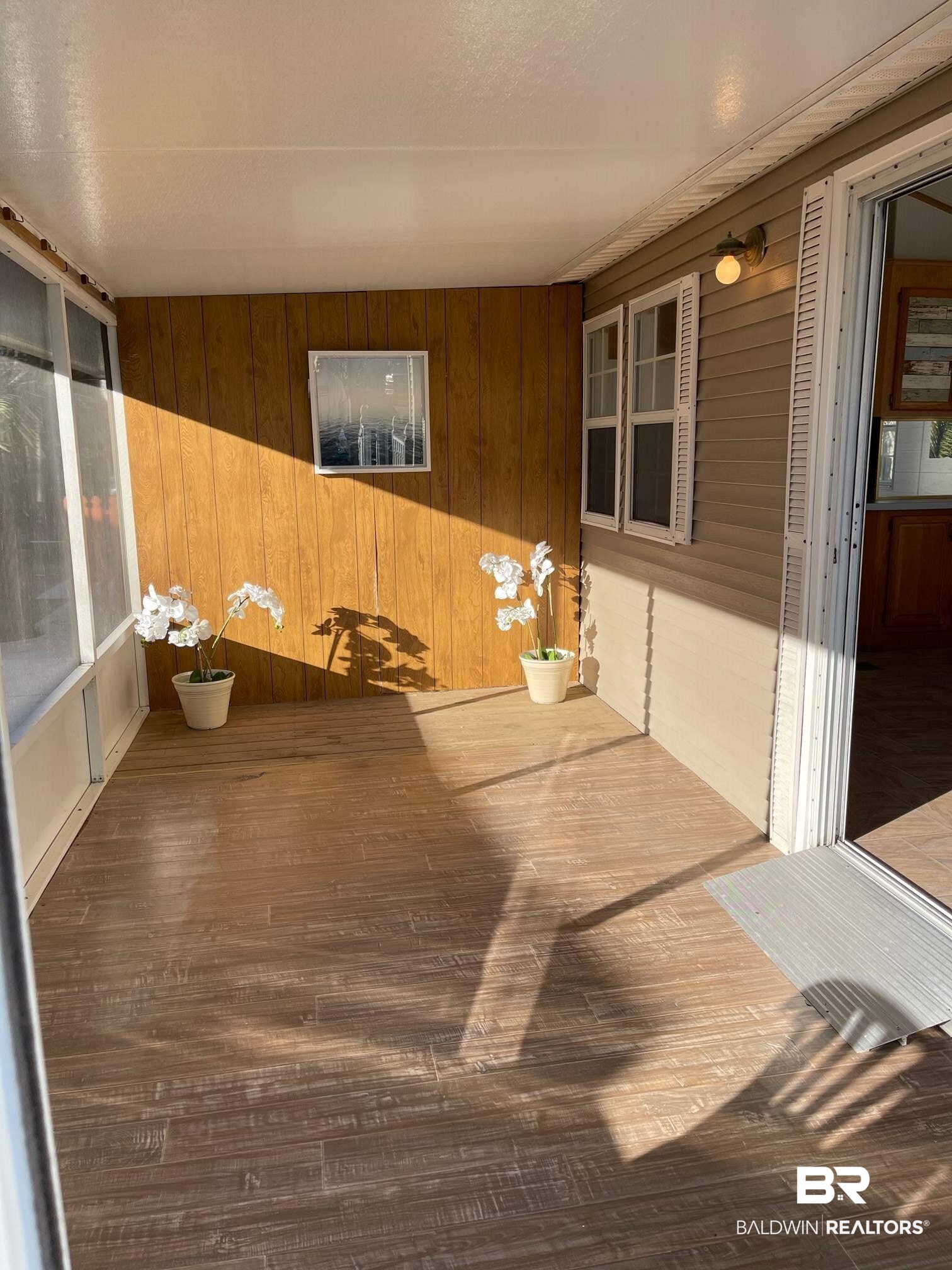 186 Defuniak Loop Lillian, AL 36549 - Photo 4 of 20 Screened-in side porch off living/dining area.