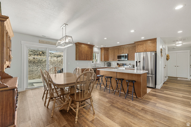 18573 South Marsh Valley Road Downey, ID 83234 - Photo 12 of 32 Dining space featuring light wood finished floors, recessed lighting, and a textured ceiling