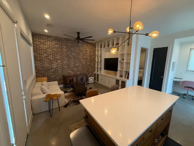 a kitchen with a table chairs refrigerator and microwave