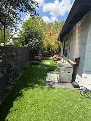 a view of a backyard with sitting area