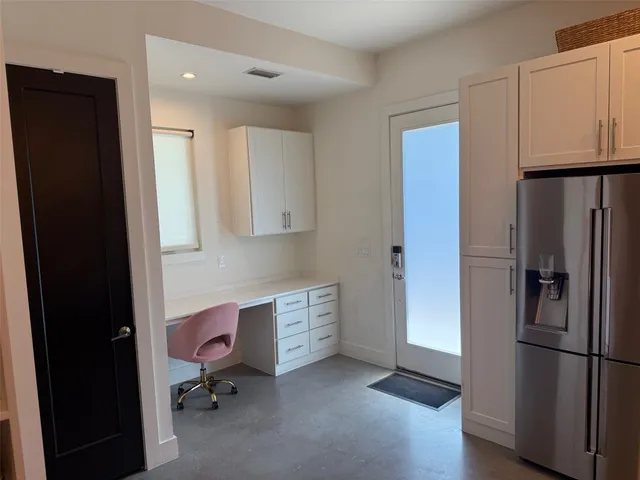a kitchen with stainless steel appliances a refrigerator and cabinets
