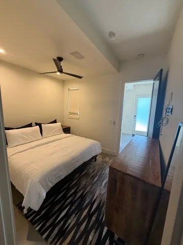 a bedroom with a bed and a mirror