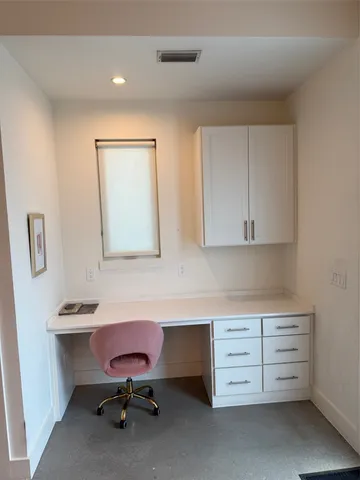 a room with cabinets and chair