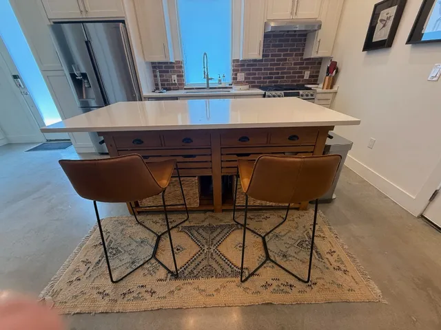 a room with table chairs and wooden floor