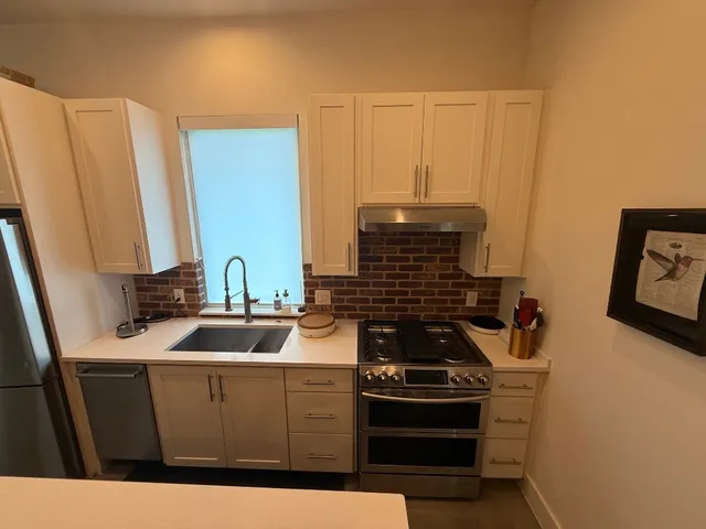 a kitchen with a sink stove and cabinets