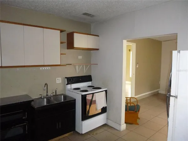 a kitchen with stainless steel appliances a stove a refrigerator and cabinets