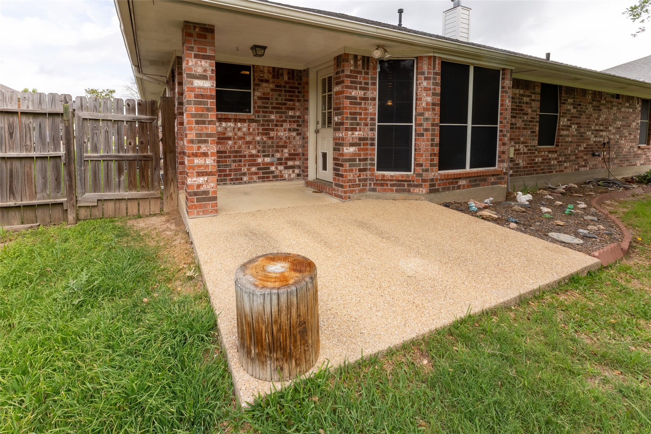 4802 Treadgold Lane Bryan, TX 77802 - Photo 24 of 27 a backyard of a house with table and chairs