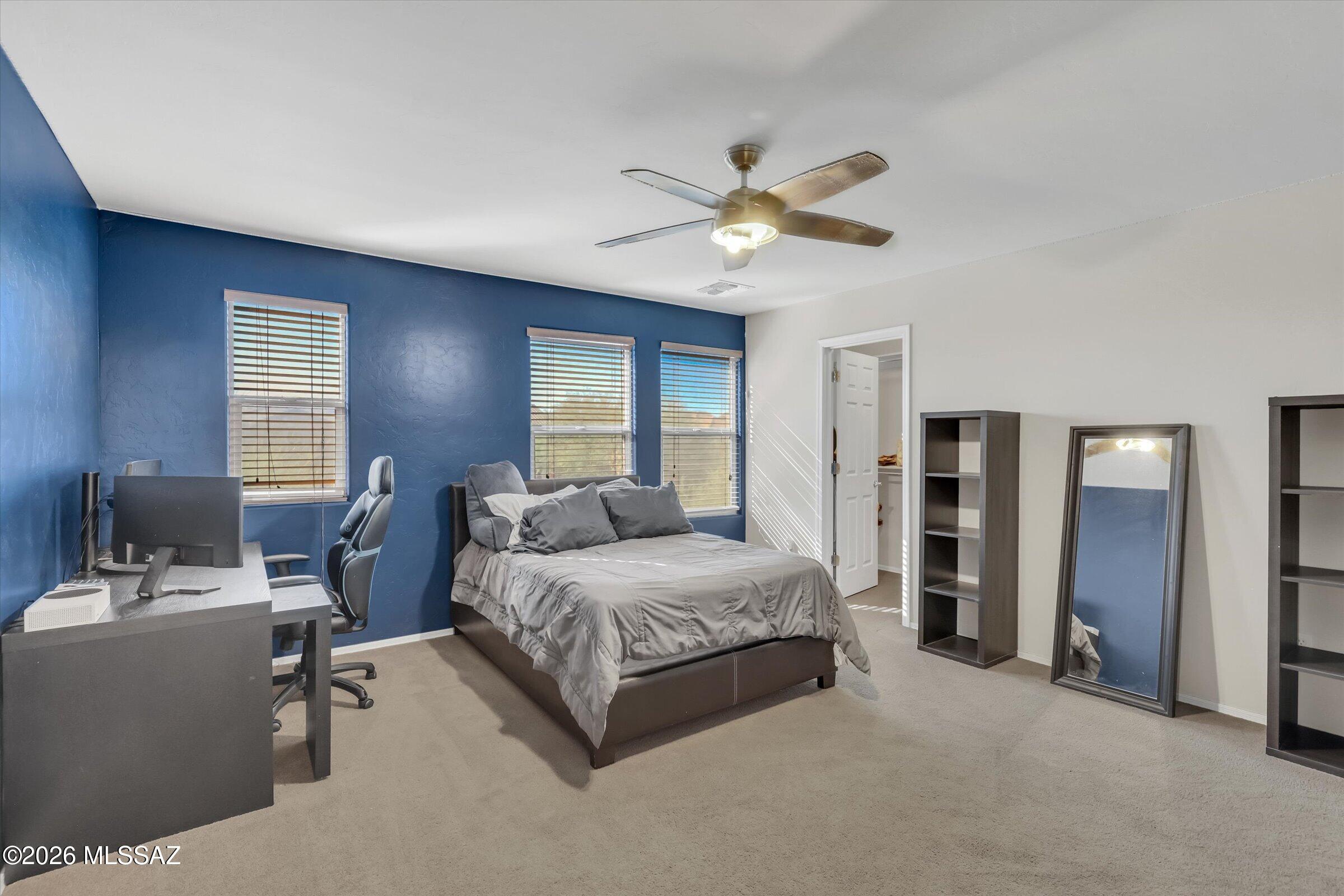 6095 South Jakemp Trail Tucson, AZ 85747 - Photo 40 of 52 a bedroom with a bed gym equipment and a window
