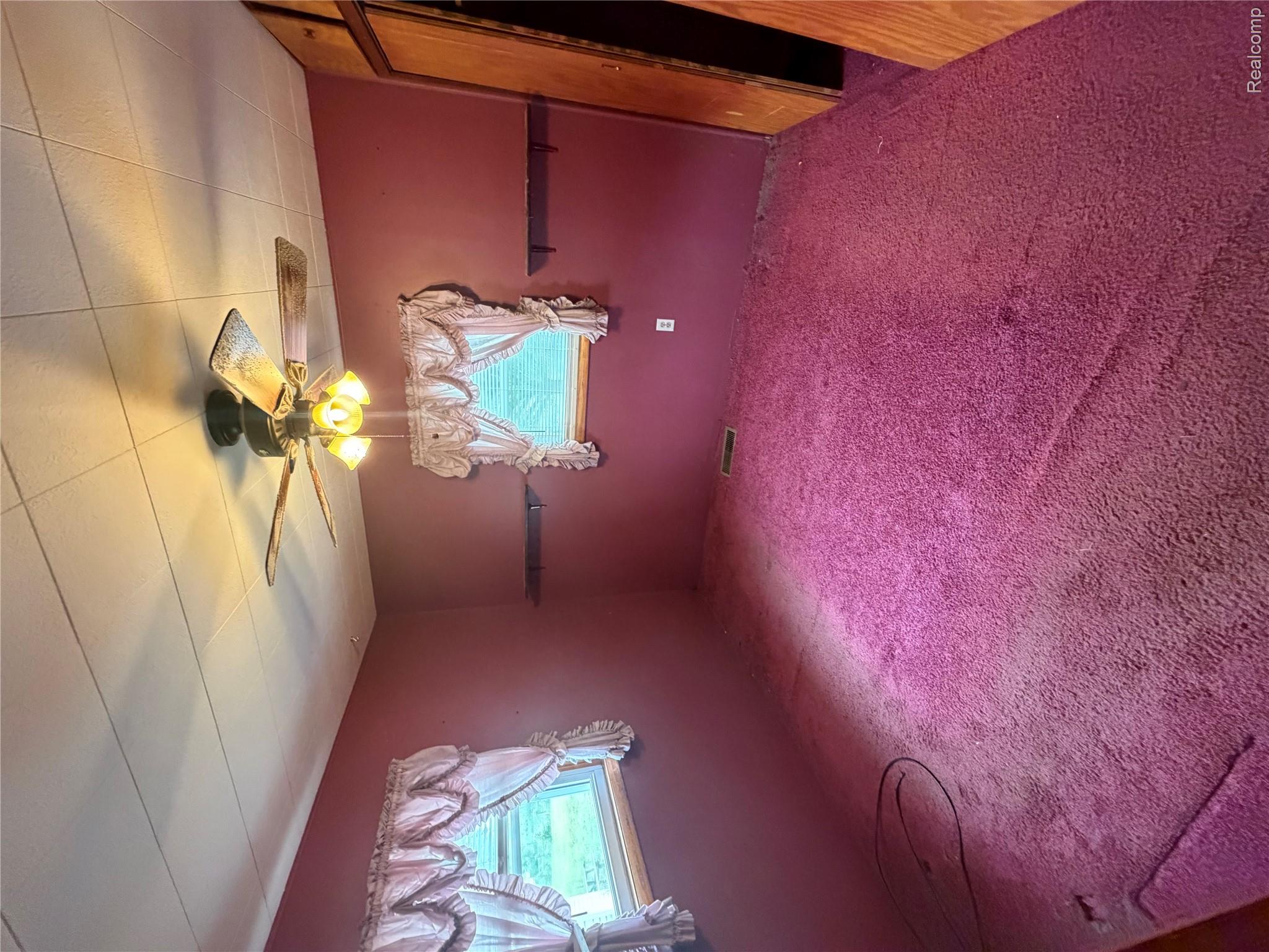 35 East Filion Road Filion, MI 48432 - Photo 16 of 24 Bedroom featuring deep fuchsia wall paint and coordinating carpet