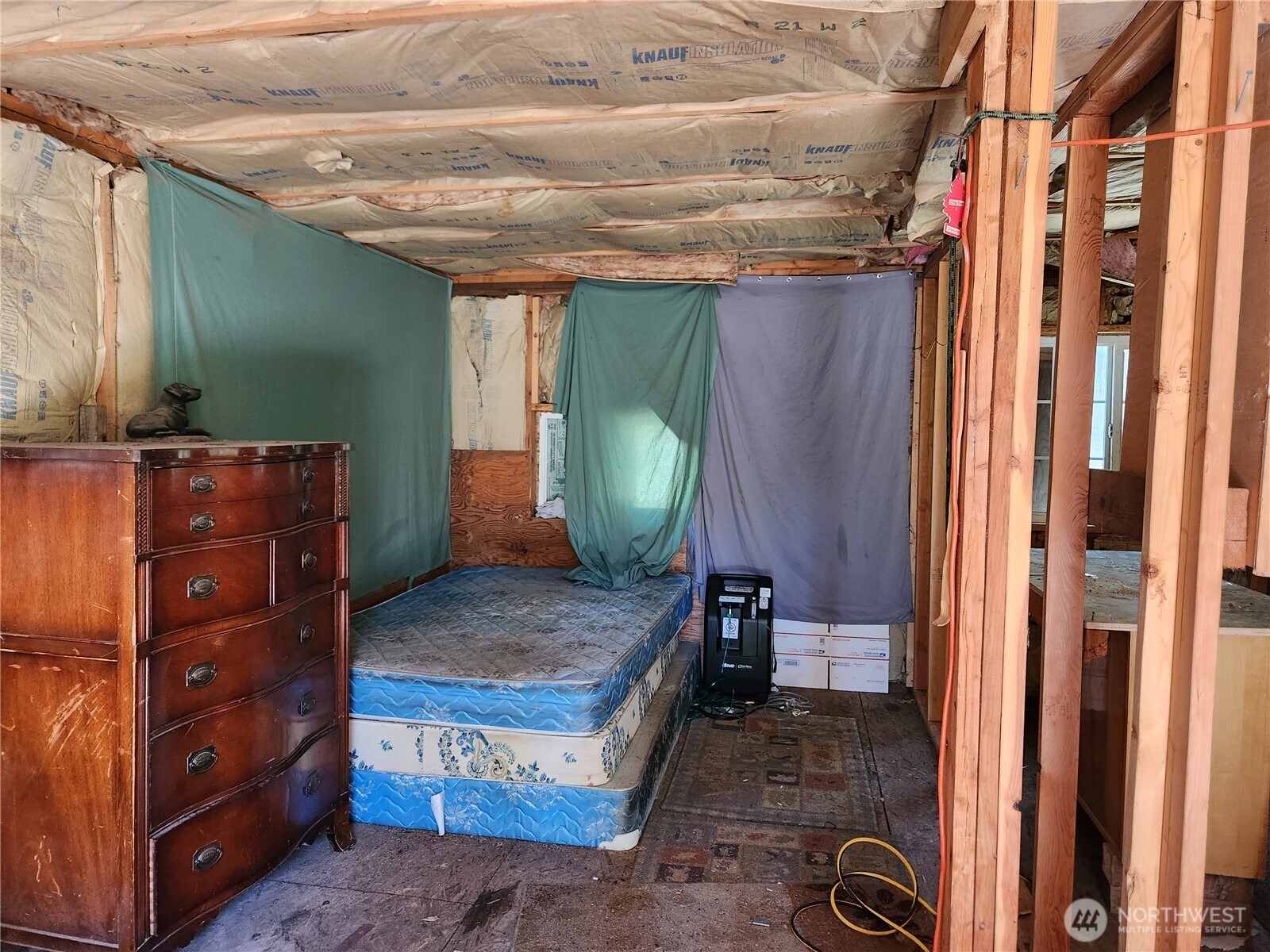 302 Klondike Road Republic, WA 99166 - Photo 5 of 10 a room with a mirror on dresser and a wooden floor