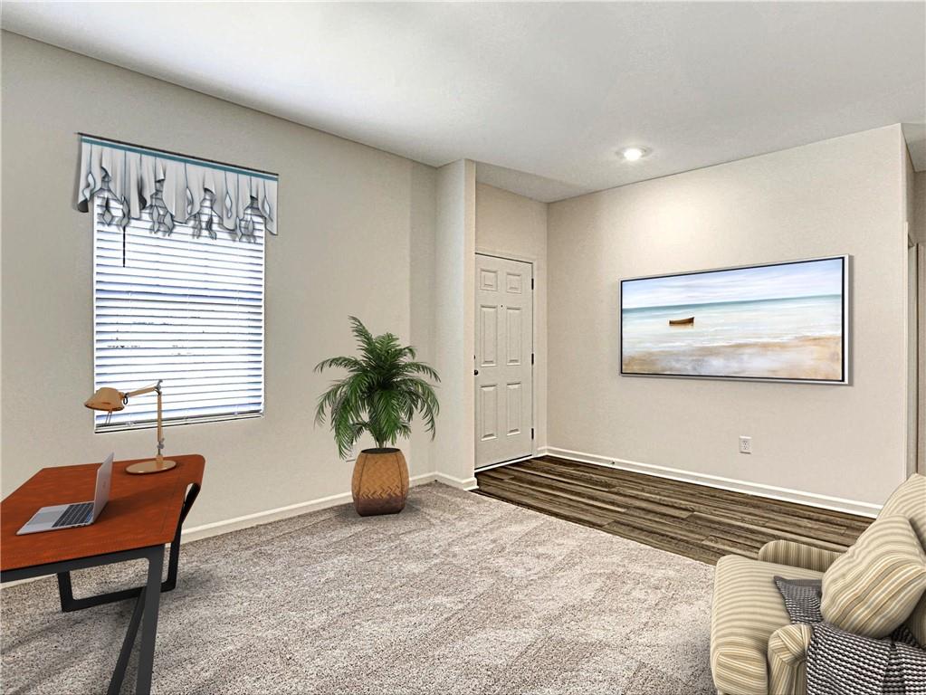 24 Rowlett Place Winder, GA 30680 - Photo 2 of 5 a bedroom with furniture and a potted plant