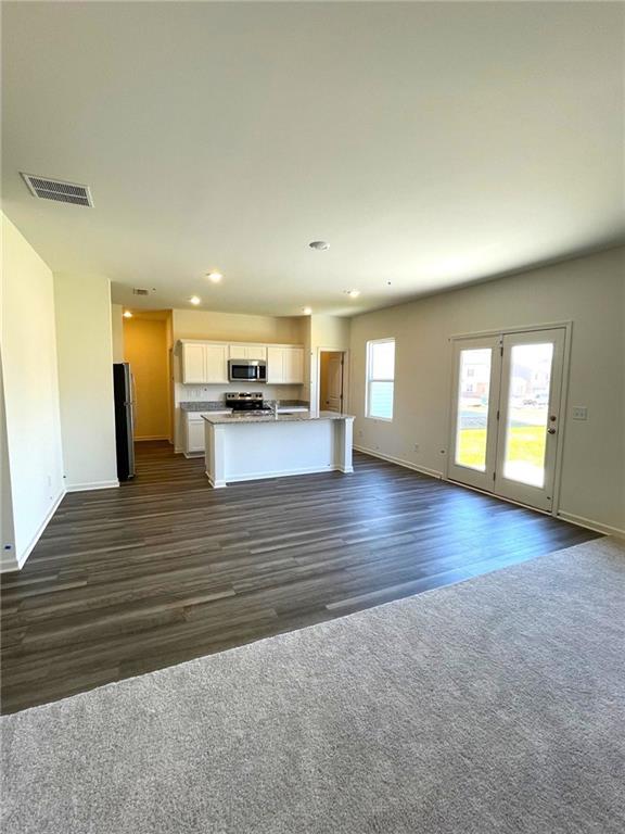 24 Rowlett Place Winder, GA 30680 - Photo 4 of 17 a view of empty room with wooden floor and window