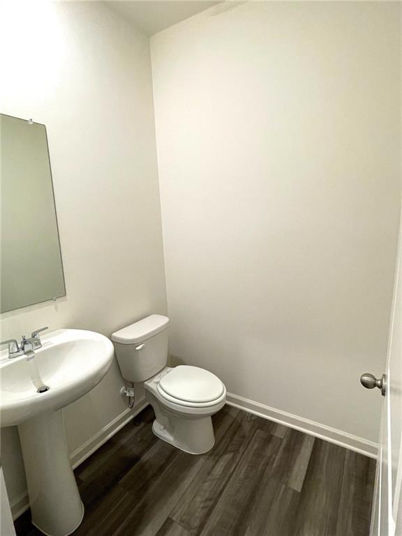 24 Rowlett Place Winder, GA 30680 - Photo 6 of 17 a white toilet sitting next to a bathroom sink