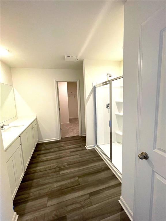 24 Rowlett Place Winder, GA 30680 - Photo 9 of 17 a view of a hallway with wooden floor and staircase