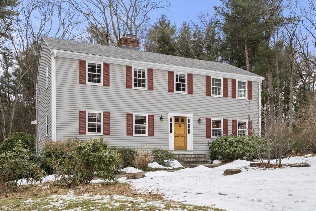 62 Rambling Road Sudbury, MA 01776 - Photo 1 of 38 a front view of a house with a yard covered in snow