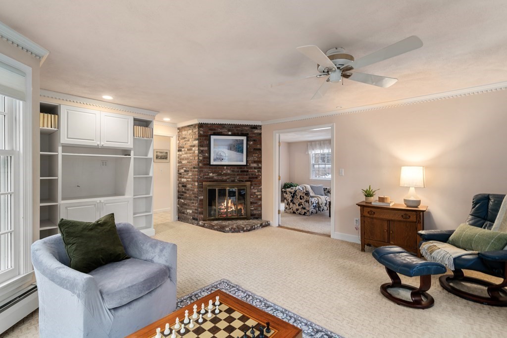 62 Rambling Road Sudbury, MA 01776 - Photo 11 of 38 a living room with furniture and a fireplace