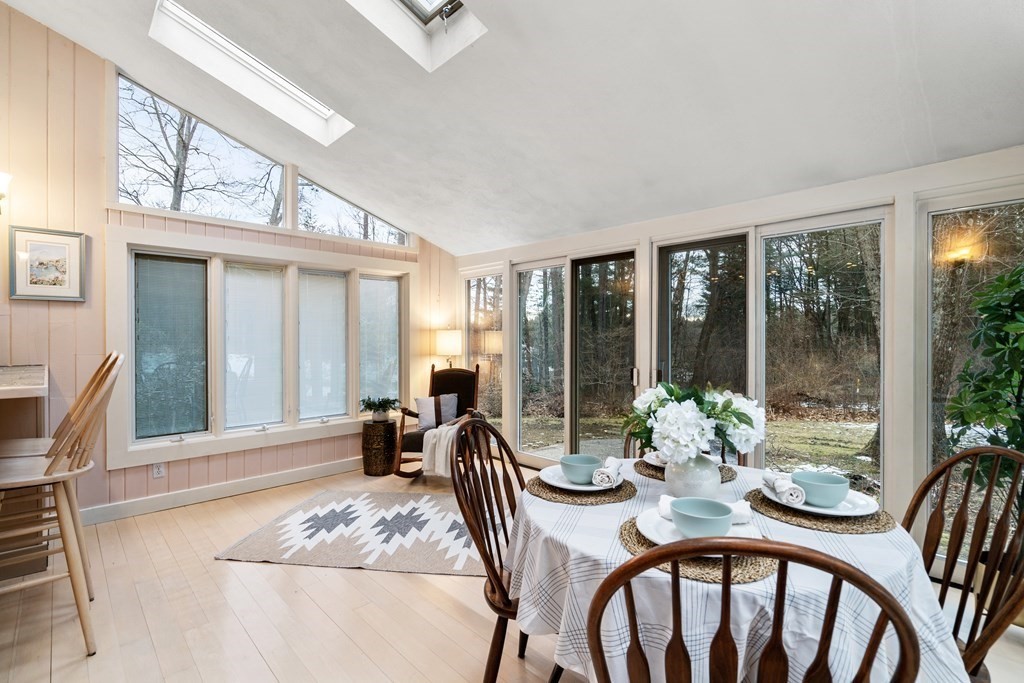 62 Rambling Road Sudbury, MA 01776 - Photo 17 of 38 a dining room with furniture large windows and a chandelier