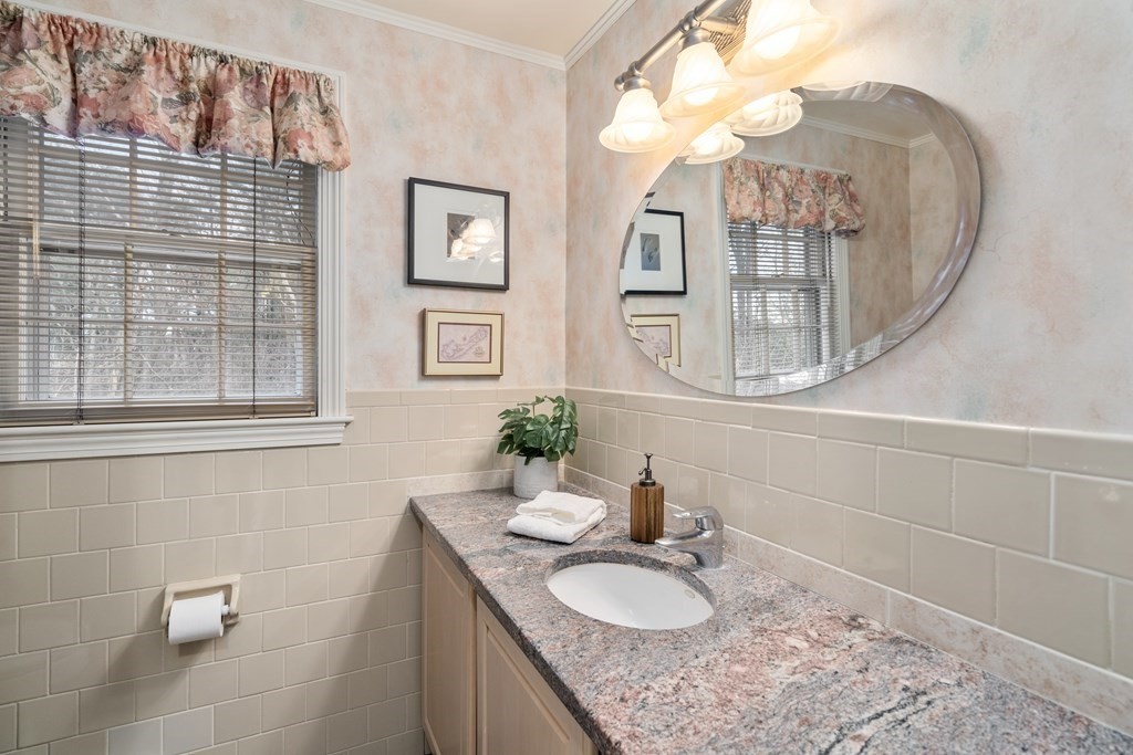 62 Rambling Road Sudbury, MA 01776 - Photo 26 of 38 a bathroom with a granite countertop sink a mirror and a shower
