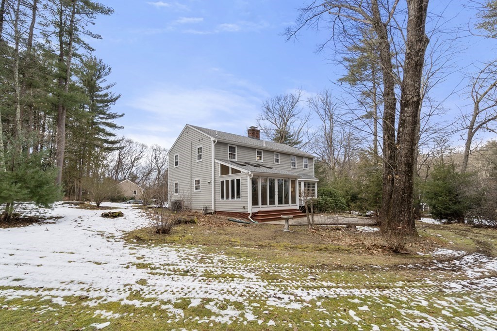 62 Rambling Road Sudbury, MA 01776 - Photo 30 of 38 a view of a house with a yard covered in snow