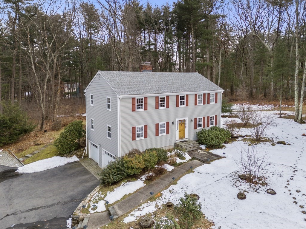 62 Rambling Road Sudbury, MA 01776 - Photo 31 of 38 a view of a white house with a yard and garden