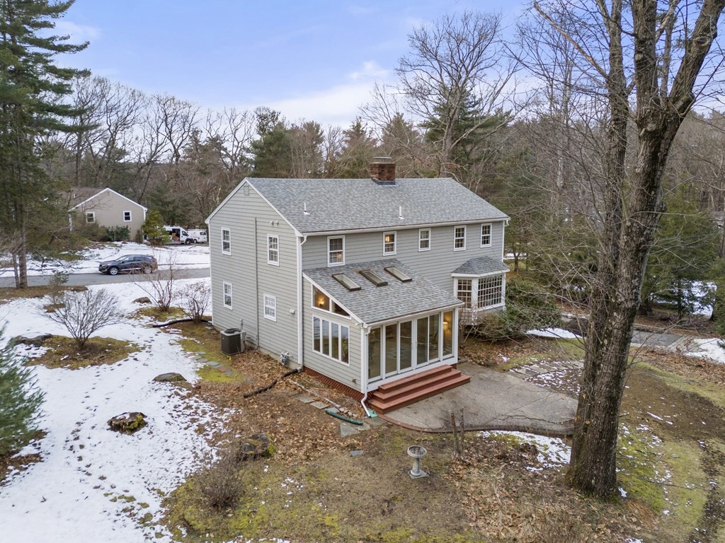 62 Rambling Road Sudbury, MA 01776 - Photo 5 of 38 a view of a house with a yard covered in snow