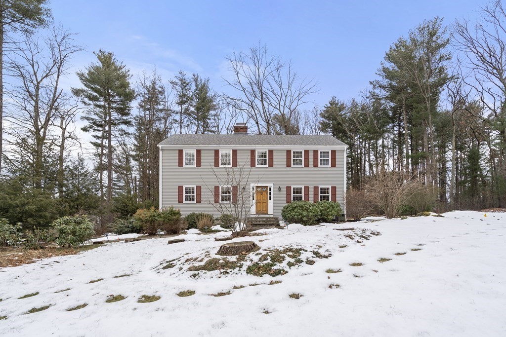 62 Rambling Road Sudbury, MA 01776 - Photo 6 of 38 a view of a white house covered in snow