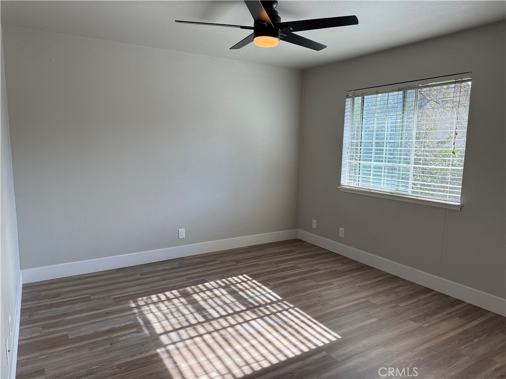 2055 Amanda, Unit 26 Chico, CA 95928 - Photo 2 of 15 a view of an empty room with wooden floor and a window