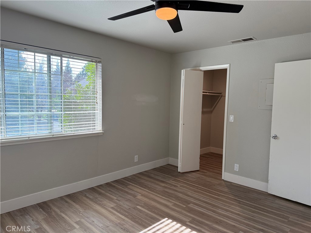 2055 Amanda, Unit 26 Chico, CA 95928 - Photo 3 of 15 a view of an empty room with wooden floor and a window