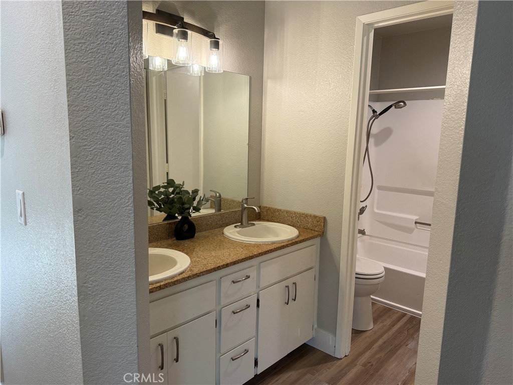 2055 Amanda, Unit 26 Chico, CA 95928 - Photo 4 of 15 a bathroom with a granite countertop sink and a mirror