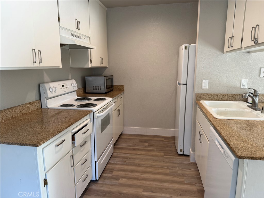 2055 Amanda, Unit 26 Chico, CA 95928 - Photo 10 of 15 a kitchen with granite countertop a sink stove and refrigerator
