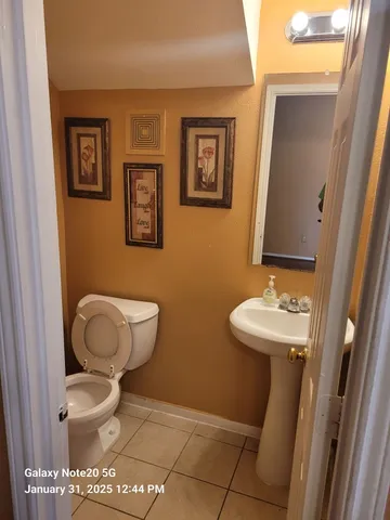 a bathroom with a toilet a sink and a mirror