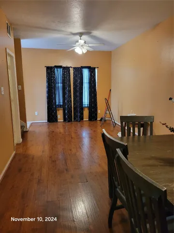 a view of a dining room with furniture and chandelier